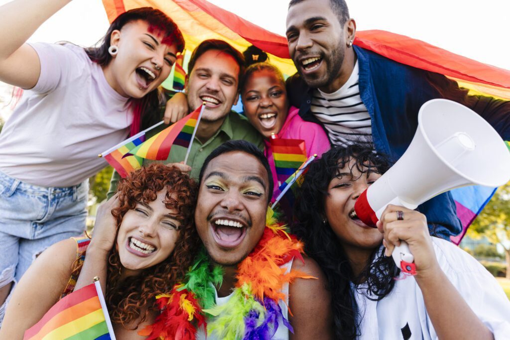 group of non-binary people multiracial diversity, demonstration lgbt concept. Diverse Group Celebrating at Pride Event with Rainbow Flags